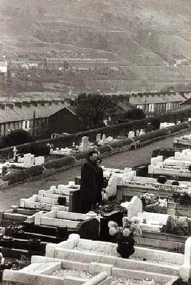 Couple visit the grave of their child, a victim of the Aberfan disaster
